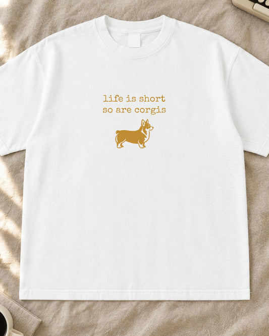 Corgi shirt, life is short so are corgis typewriter text with a small corgi stamp print in mustard on a white Comfort Colors tee